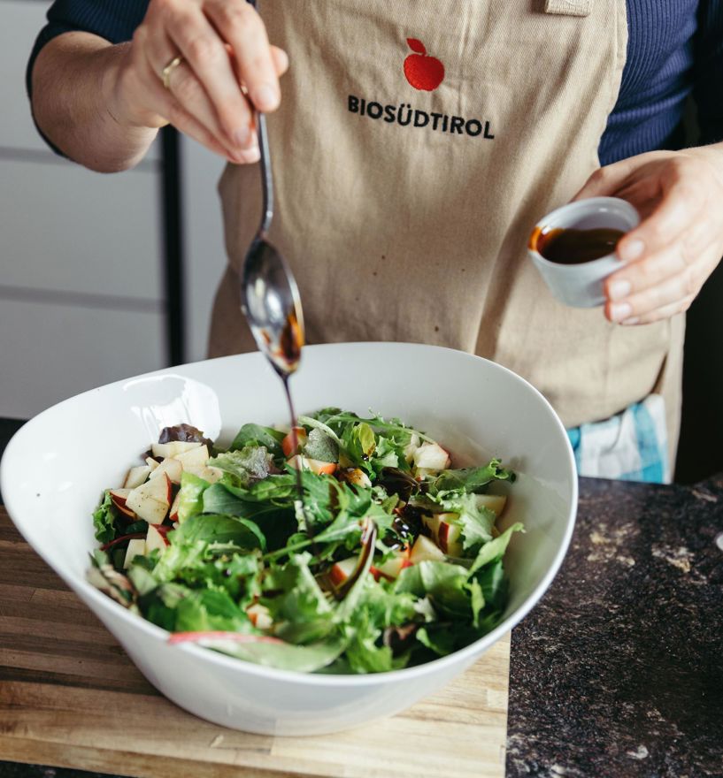 Organic farmer Sissy is dressing the apple salad
